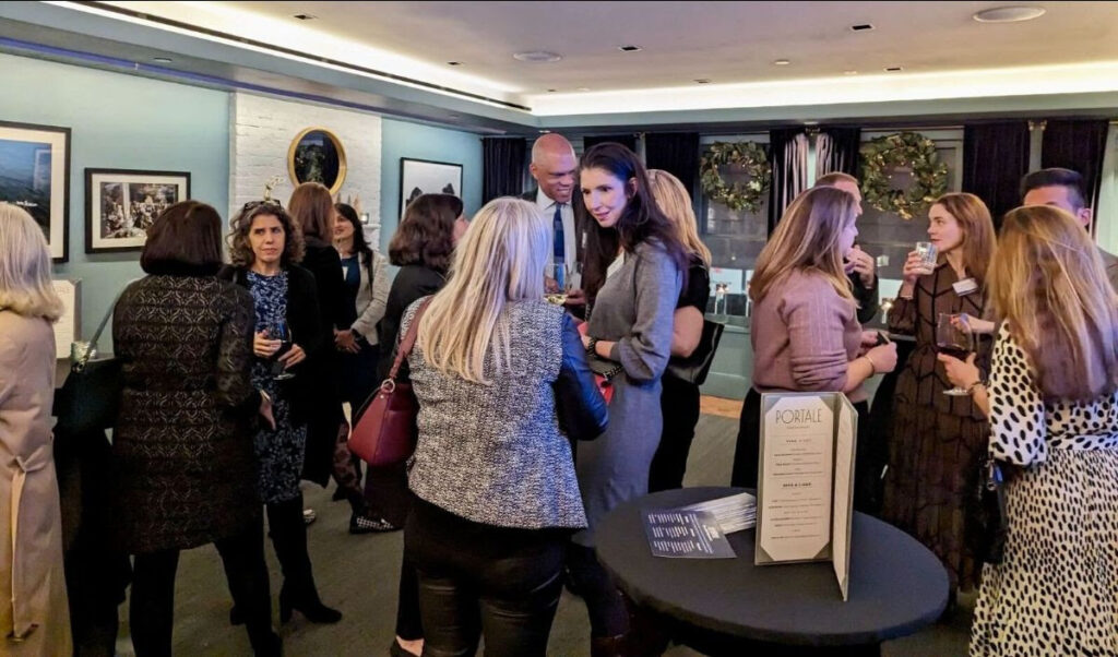 A group of people celebrating at The CDO Network’s “Toast to Philanthropy” cocktail gathering in greater NYC.